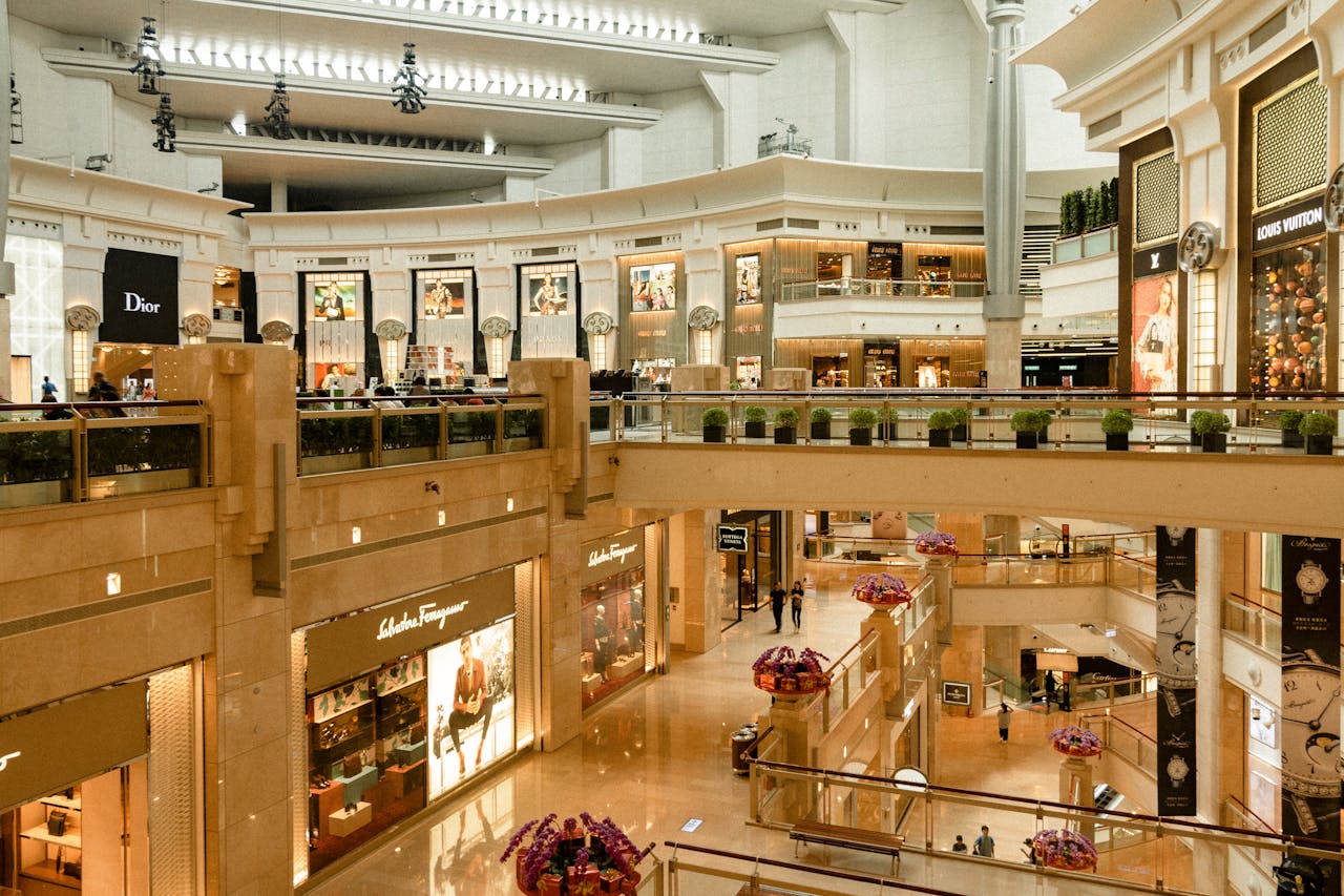 Mastering the First Impression: Your intriguing post title goes here Contemporary design of big mall interior with ribbed column and decorative elements on ceiling with glowing corridors illuminated by artificial lights and signboards with inscriptions